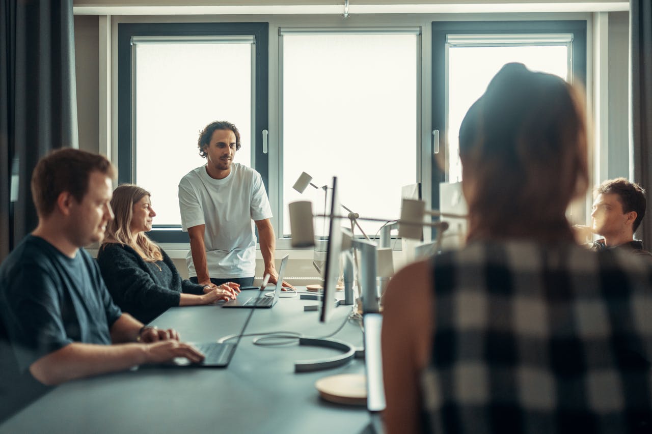 A diverse team engaged in discussion during a collaborative office meeting.
